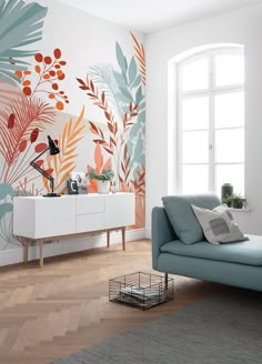 a blue couch sitting in front of a window next to a white wall with plants on it