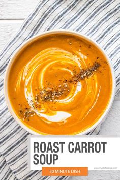 roasted carrot soup in a white bowl on a blue and white striped towel with the title roast carrot soup