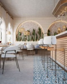 the interior of a restaurant with tables, chairs and plants hanging on the brick wall