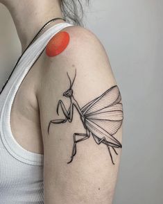 a woman with a tattoo on her arm that has an image of a praying mantissa