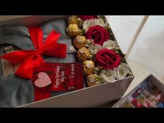 a gift box filled with chocolates, roses and other assorted candies for someone's special occasion