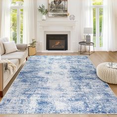 a living room with a blue rug on the floor and a fire place in the corner