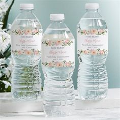 three bottled water bottles with labels on them