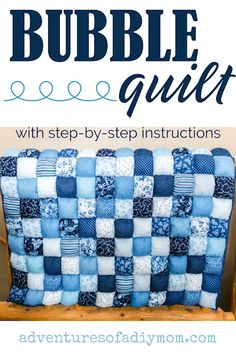 a blue and white checkered pillow with the words bubble quilt on it