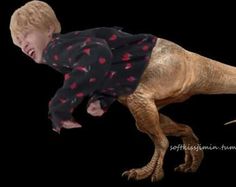 a young boy riding on the back of a dinosaur