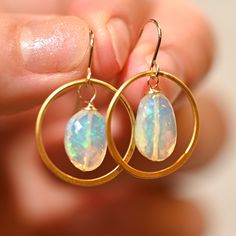 Pinfire Golden Hoop earrings matched with two gorgeous opals that are a green misty hue. These really bring a fun look to any outfit. Golden Hoops - Gold Vermeil (over .925 sterling silver) Ethiopian Opals - 14 x 9 mm 14 K Gold Filled Ear Wire Length: 1 1/4” Small Hoop Opal Earrings For Gift, Everyday Opal Jewelry With Gemstones, Everyday Opal Gemstone Jewelry, Hypoallergenic Opal Dangle Jewelry, Oval Opal Jewelry With Matching Earrings, Minimalist Ethiopian Opal Round Jewelry, Hypoallergenic Opal Drop Earrings, Hypoallergenic Round Opal Jewelry, Opal Hoop Earrings As A Gift