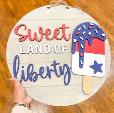 a sign that says sweet land of liberty with an ice cream cone on it and stars