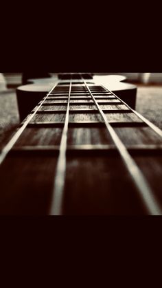 a close up view of an acoustic guitar's frets