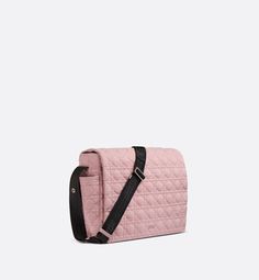 a pink quilted bag with black straps