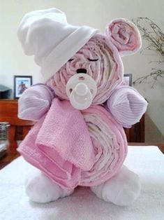 a teddy bear wrapped in pink and white clothing