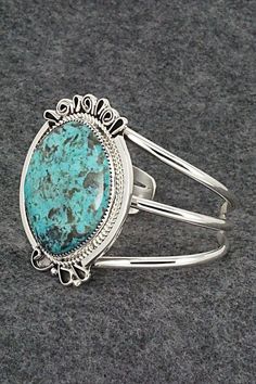 This stunning turquoise and sterling silver bracelet was made by Navajo silversmith Leslie Nez. The back is signed Leslie Nez and Sterling.Size: 5 1/2" (will fit up to a 6 5/8" wrist)Gap: 1 1/8"Length: 2 1/4"Width: 1 3/4"Free shipping on all orders! We ship with USPS and always include tracking. All orders ship within a day of payment.Returns are accepted up to 30 days after you receive your order. Just send us a message. Our shop offers cash back or store credit. The item must be returned in ne Sterling Silver Bracelet, Native American Jewelry, Turquoise Sterling Silver, Free Jewelry, Sterling Silver Bracelets, Silver Bracelet, Gap, Turquoise, Bracelet