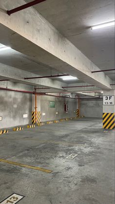 an empty parking garage with yellow and black stripes