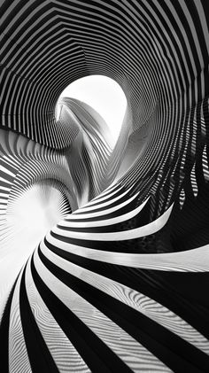 an abstract black and white photo of a spirally structure with light at the end