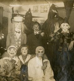 an old black and white photo of clowns posing for a group shot with their mouths open