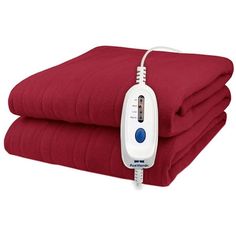 an electric heated blanket is on top of two red blankets