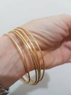 Gold bangle bracelet, made of a 1.5 mm gold plated wire, designed in a minimalist, simple chic.Available as a single gold bangle, set of 2 or 3, 4 or even 5 gold bangles these bracelets will make a beautiful addition for every look, day or night.Dimensions:The bangle bracelet diameter is available in sizes: small (2.35"), medium (2.5") or large (2.75"). If you require a different size just convo me.The bangle is 1.5mm thickFor a thicker version of gold bangles, follow the link below:https://www. Single Gold Bangle, Gold Bangle Bracelet For Women, Simple Gold Bangle, 14k Gold Bangle Bracelet, Plain Gold Bangles, Solid Gold Bangle, Bangle Bracelet Gold, Gold Bracelet Simple, Gold Bangles For Women