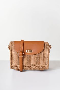 Experience chic and playful charm with our Renata Tan Woven Purse. Perfect for warmer weather, this stunning crossbody boasts a beautiful woven rattan design and a comfortable adjustable vegan leather shoulder strap. Make a statement and add a touch of whimsy to any outfit with this must-have accessory. Summer Crossbody Straw Bag With Woven Leather, Spring Rattan Bag With Adjustable Strap, Casual Rattan Shoulder Bag With Adjustable Strap, Brown Braided Straw Bag For Spring, Chic Braided Shoulder Bag For Spring, Chic Braided Straw Bag, Spring Brown Braided Straw Bag, Spring Braided Brown Shoulder Bag, Spring Braided Brown Straw Bag