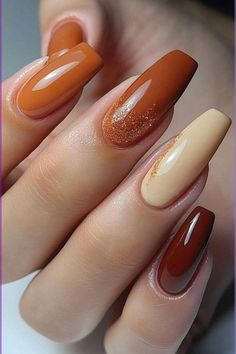 Get ready for fall with these stunning coffin-shaped nails! Featuring a mix of warm brown shades and a hint of gold glitter, this design is perfect for cozy sweater weather. #fallnails #coffinnails #neutralnails #nailart #autumnvibes #nailinspo #naildesigns #brownglitter #nailsofinstagram #manicure #pedicure #beauty #fashion #coffinnails, #neutralnails, #brownglitter, #nailinspo, #naildesigns, #nailsofinstagram, #manicure, #pedicure, #autumnvibes, #diy, #nailinspiration, #nailstagram, #fallstyle Pumpkin Spice Nails, Simple Fall Nails, November Nails, Fall Manicure, Fall Nail Trends, Cute Nails For Fall, Thanksgiving Nails, Fall Nail Art, Fall Nail Colors