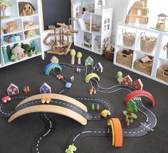 a play area with toys and bookshelves on the floor