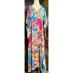 New With Tags Size Small This Gorgeous Maxi Dress By Johnny Was Has A Breezy Bohemian Look. The Long Dress Has A Floral & Mosaic Patchwork Pattern. It Has Three Quarter Sleeves That Have Romantic Ties. This Dress Has A Flattering V-Neck With Buttons Down The Bodice. It Has A Tiered Loose Dropwaist. The Beautiful Dress Is Unlined & Does Not Come With A Slip. It Has Pockets! Measurements Laying Flat: Length 56 1/4” Bust 18 1/4” Waist 18.5” Hips 20” Vibrant Floral Print Maxi Dress, Vibrant Colorful Floral Print Maxi Dress, Vibrant Multicolor V-neck Dress, Pink Vibrant Print Dress For Beach Cover-up, Colorful V-neck Dress With Floral Print, Vibrant Multicolor Floral Print Dresses, Colorful Floral Print V-neck Maxi Dress, Pink V-neck Maxi Dress With Vibrant Print, Vibrant Tropical Print Multicolor Dress