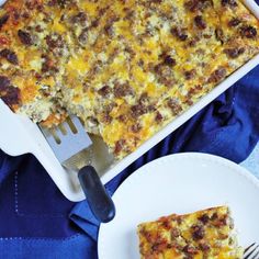 a casserole dish with meat and cheese on it next to a fork and plate