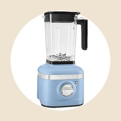 a blue blender sitting on top of a white circle with the words kitchen aid written in it