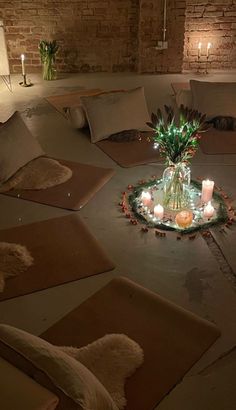 a living room filled with lots of pillows and candles