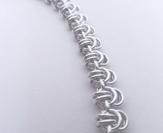 "Handmade sterling silver necklace. Polished silver. An adapted version of the traditional viking king chainmaille. Chain width 8.0 mm. Matching bracelet: https://www.etsy.com/listing/999230200 You order not the exact item on the image, but it's likeness to your specified length. Please contact the shop owner for other dimensions than listed. 12.5\" (31.8 cm) 13\" (33 cm) 13.5\"(34.3 cm) 14\" (35.6 cm) 14.5\" (36.8 cm) 15\" (38.1 cm) 15.5\"(39.4 cm) 16\" (40.6 cm) 16.5\" (41.9 cm) 17\" (43.1 cm) Diy Chainmail, Chainmaille Jewelry Patterns, Chain Maille Patterns, Norse Necklace, Viking King, Jump Ring Jewelry, Chain Jewellery, Chainmail Necklace, Wire Jewelery