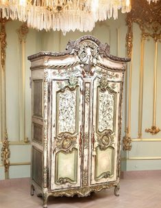 an ornate armoire in the middle of a room