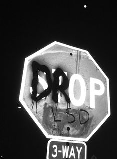 a stop sign that has been vandalized with graffiti on it and the words 3 - way below it