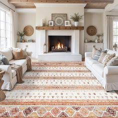 a living room filled with furniture and a fire place in the middle of the room