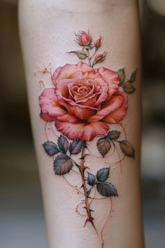 a rose tattoo on the leg with leaves and vines around it's edges,