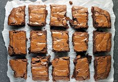 brownies are arranged on top of wax paper and ready to be cut into squares