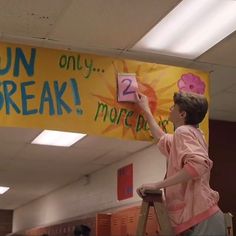 a woman holding up a sign that says run break 2 more lives