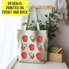 This canvas shopping tote features a delightful design of vibrant, ripe strawberries adorning both sides, creating an inviting and charming aesthetic, in rich hues of red and green, with intricate details that capture the essence of their freshness and sweetness.  Crafted from a robust 10oz./yd² natural cotton canvas fabric, this tote promises exceptional durability, ensuring it withstands the test of time. Its design is elegantly simple, featuring two comfortable shoulder straps that make carry Rectangular Bags With Strawberry Print As Gift, Rectangular Strawberry Print Bag As A Gift, Rectangular Bags With Strawberry Print For Gifts, Rectangular Bag With Strawberry Print As Gift, Red Bag With Strawberry Print As Gift, Rectangular Strawberry Print Bag For Gifts, Summer Strawberry Print Bags For Daily Use, Casual Rectangular Bag With Strawberry Print, Summer Strawberry Print Bag For Daily Use