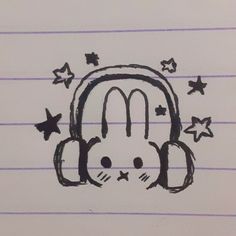 a drawing of a headphone with stars around it and the letter m in black ink