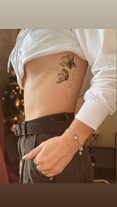 a woman with a flower tattoo on her stomach