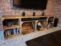 an entertainment center made out of pallet wood with speakers and bookshelves on each side