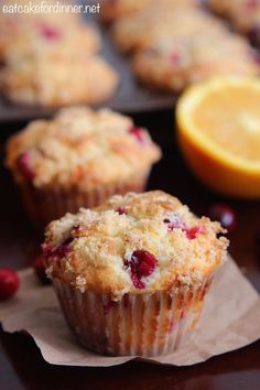 muffins with cranberries and orange slices on the side