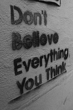 graffiti on the side of a building that says don't believe everything you think