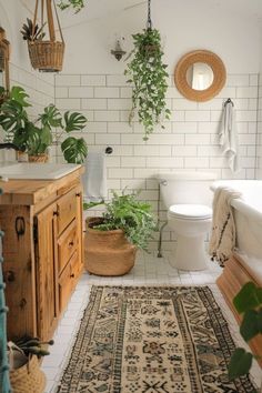 a bathroom with plants and rugs on the floor