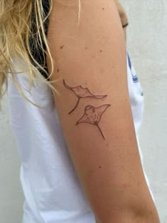 a woman with a small tattoo on her arm