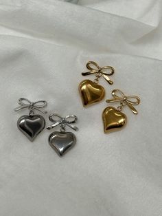 The Sweetheart Bow Earrings ✨ *listing is for one pair~ choose between 2 different styles in 2 colors!  Waterproof Posts with attached bow & heart pendants (18k Gold Plated/Stainless Steel)  Hypoallergenic, Can be worn all the time! 🫶 Made with love Cute Gold Double Heart Earrings, Cute Double Heart Gold Earrings, Cute Gold Heart Beaded Earrings, Cute Gold Heart Bead Earrings, Cute Gold Heart Earrings With Heart Beads, Heart Shaped Bow Jewelry For Gift, Heart-shaped Bow Jewelry Gift, Heart-shaped Earrings With Bow For Gift, Bow Earrings Gold