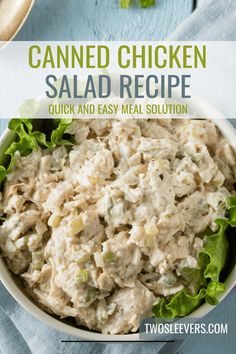 a bowl filled with chicken salad and lettuce on top of a blue table