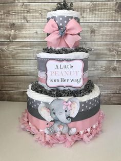 a three tiered baby shower cake with an elephant on top