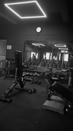 an empty gym with rows of exercise equipment