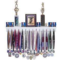 an assortment of medals and trophies on a shelf