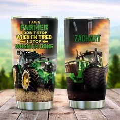 two green and black farm tractor tumblers sitting on top of a wooden table