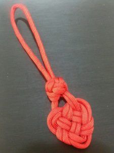 an orange knot on a black surface