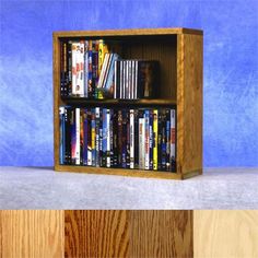 a wooden book shelf filled with dvd's